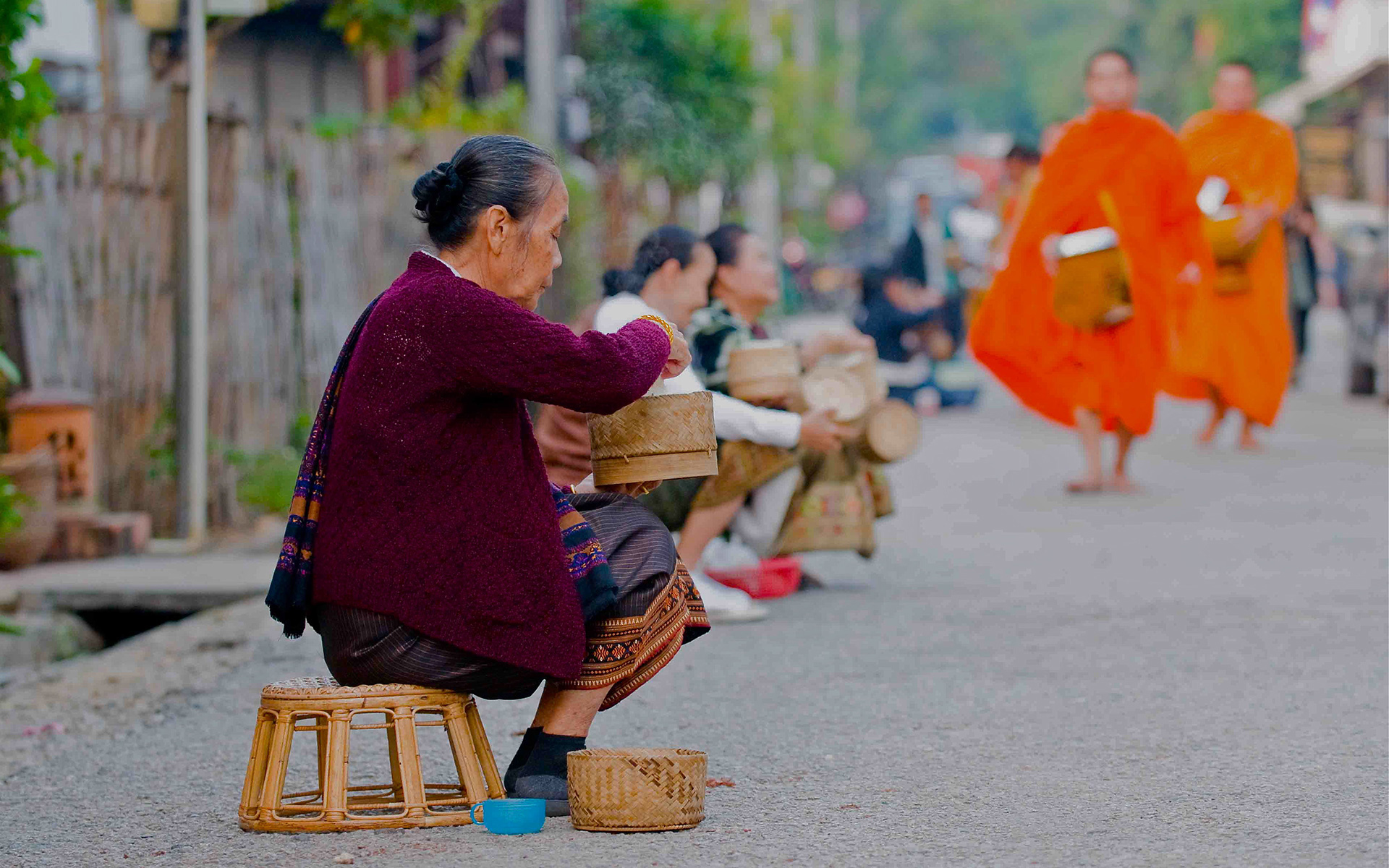 The Locals Await to Offer Food to the Monks