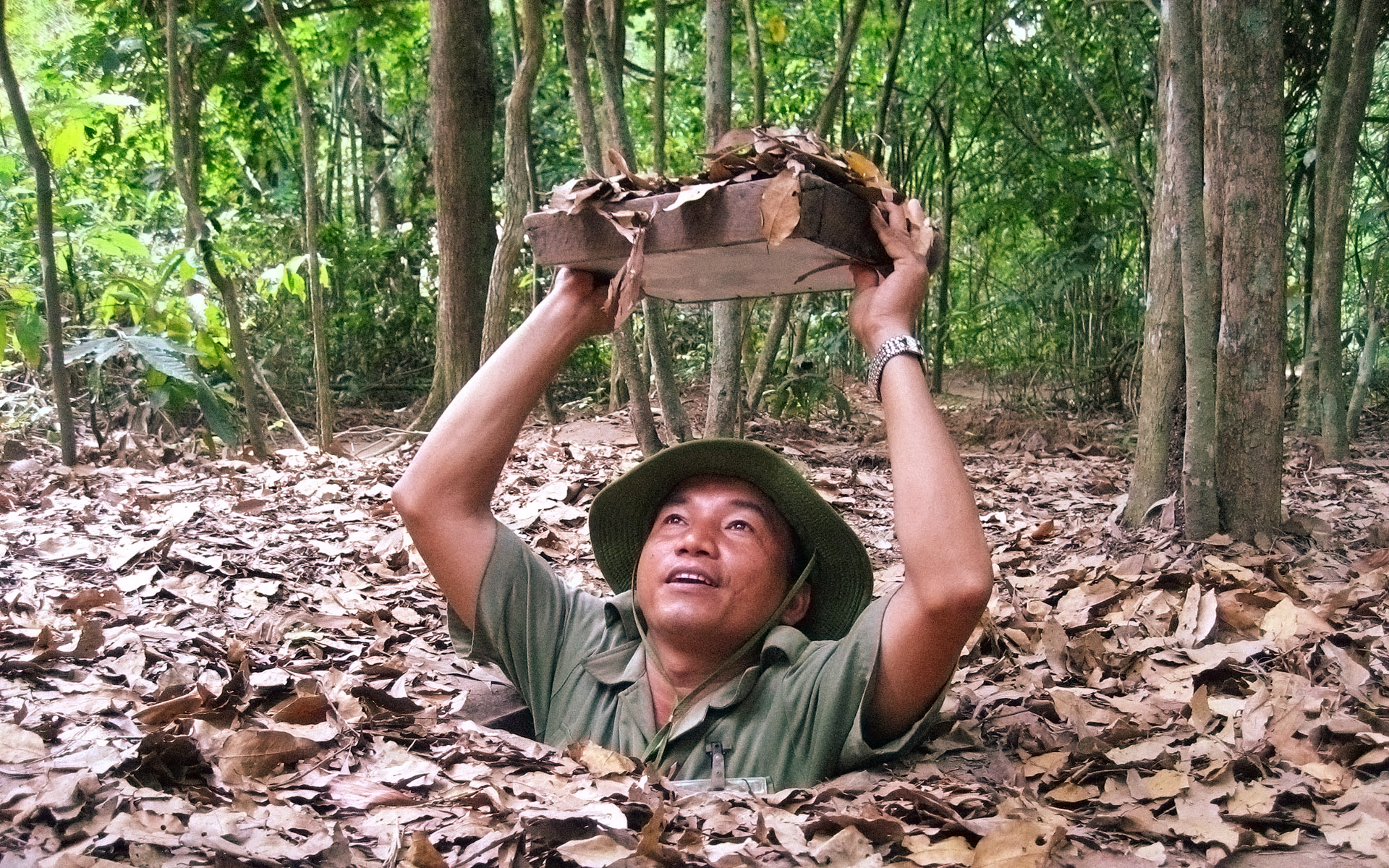 Entrance to Cu Chi Tunnels surrounded by lush greenery in Cu Chi District